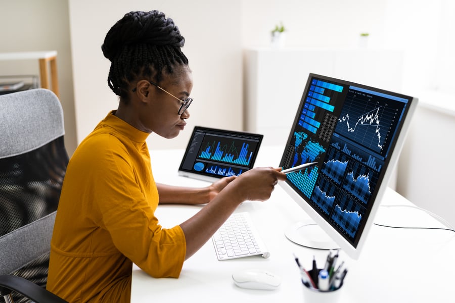 A marketing professional studies marketing attribution models on her computer screen
