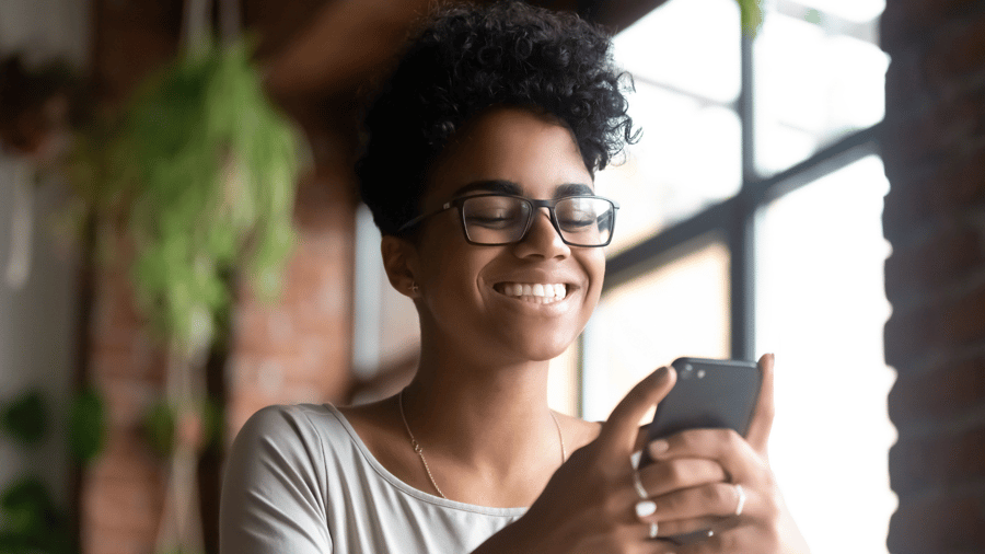 young-woman-office-smiling-at-phone