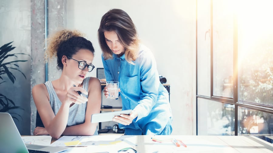 two-young-women-meeting-marketing-discussion
